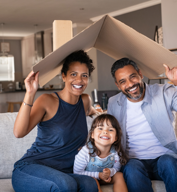 Couple and daughter posing with moving box