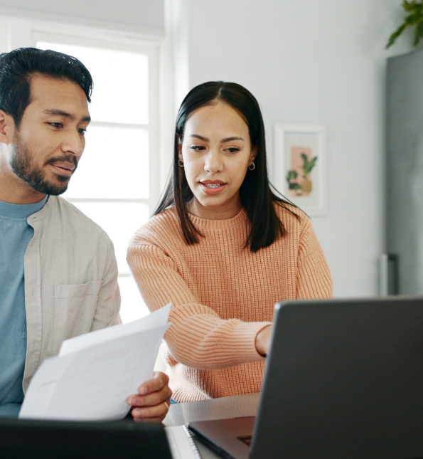 man and woman looking at laptop