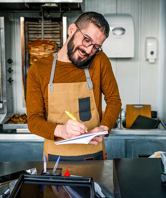 Man working in a meat shop taking orders