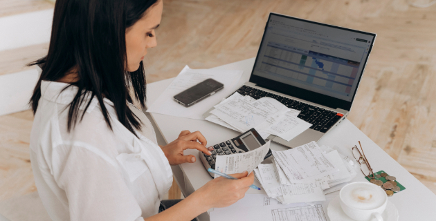 woman accounting receipts on laptop