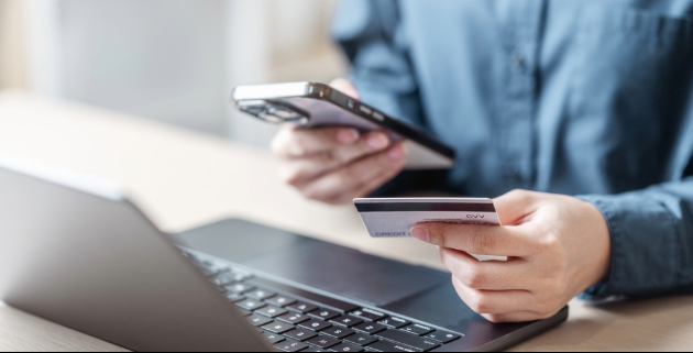 man typing credit card info into cellphone