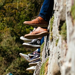 People with their feet hanging off a wall