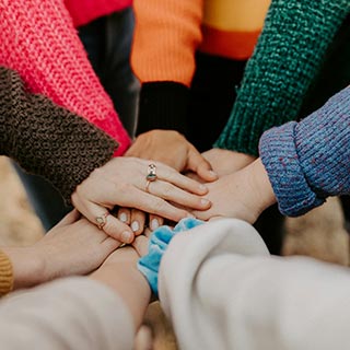 Group of people with their hands in