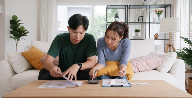 younger couple sitting on sofa