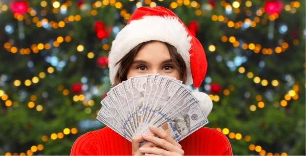 woman in santa hat holding cash