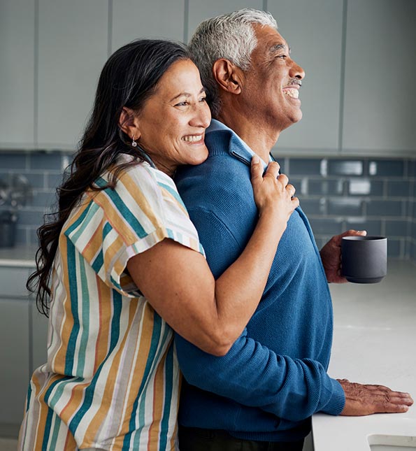 Couple smiling in their kitchen