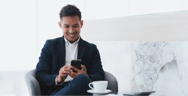 man in white room on cell phone