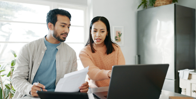 man and woman looking at laptop