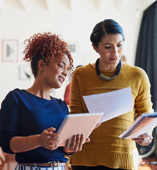 Two coworkers looking at paperwork.