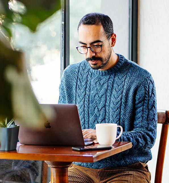Man using laptop at a coffee shop